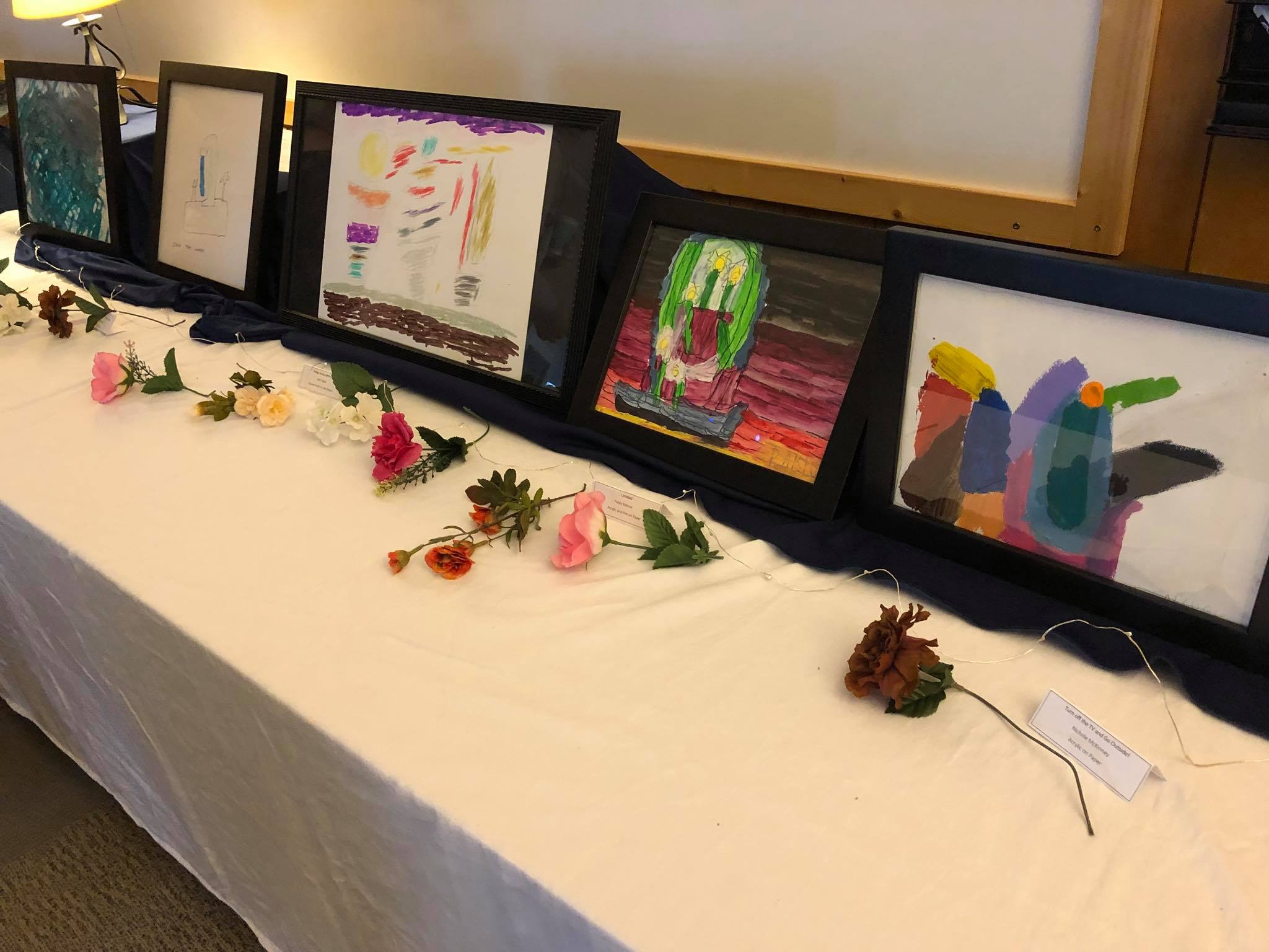 table of displayed art and flowers