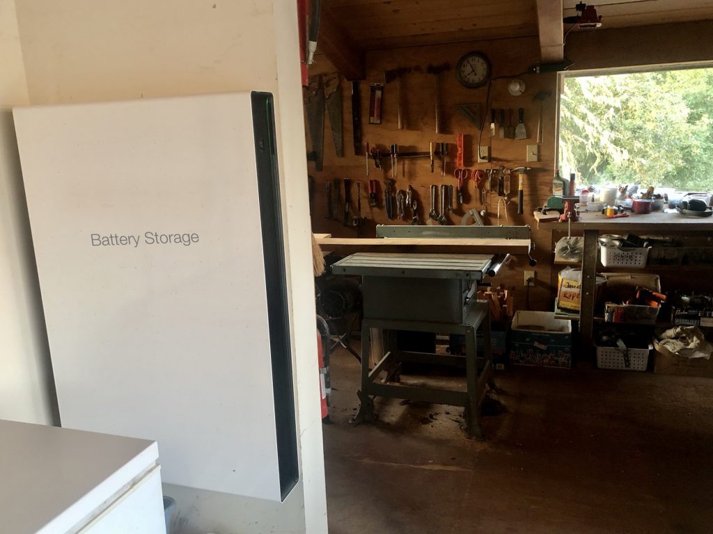 Battery storage in a garage next to a workshop