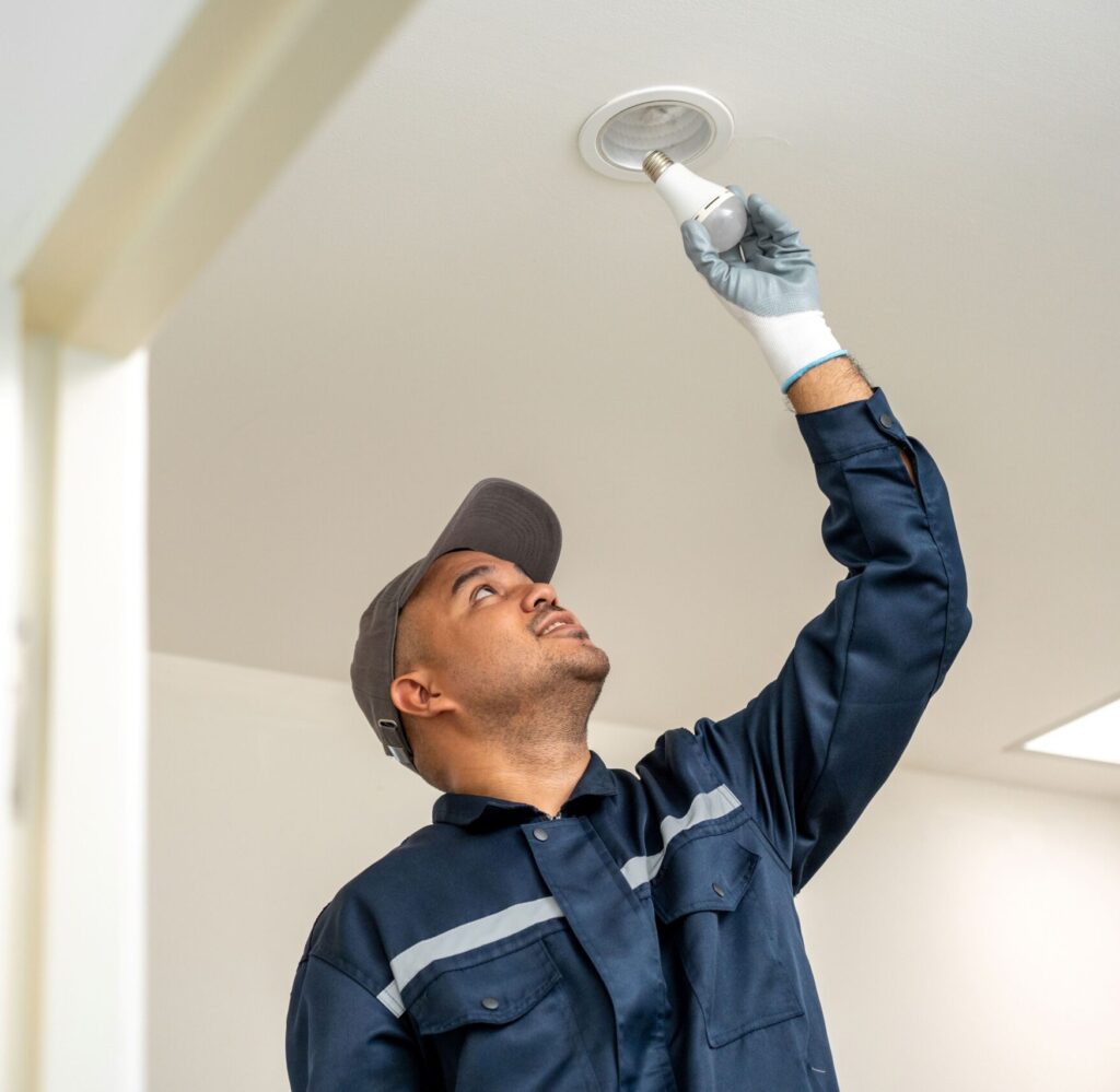 man installing lighting at a business