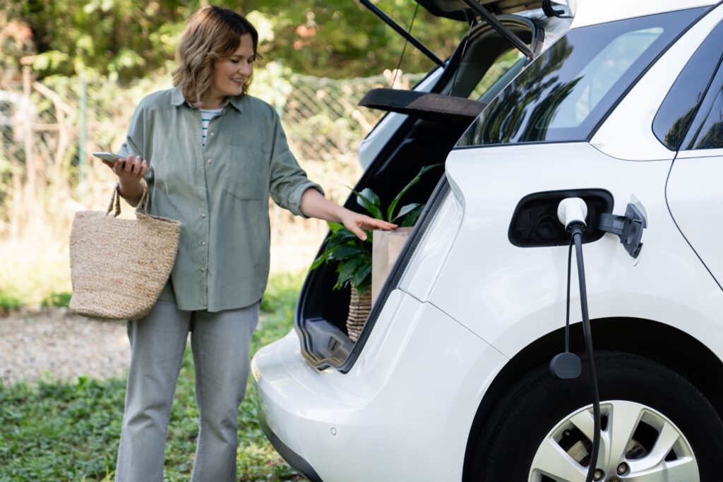 woman charging electric vehicle